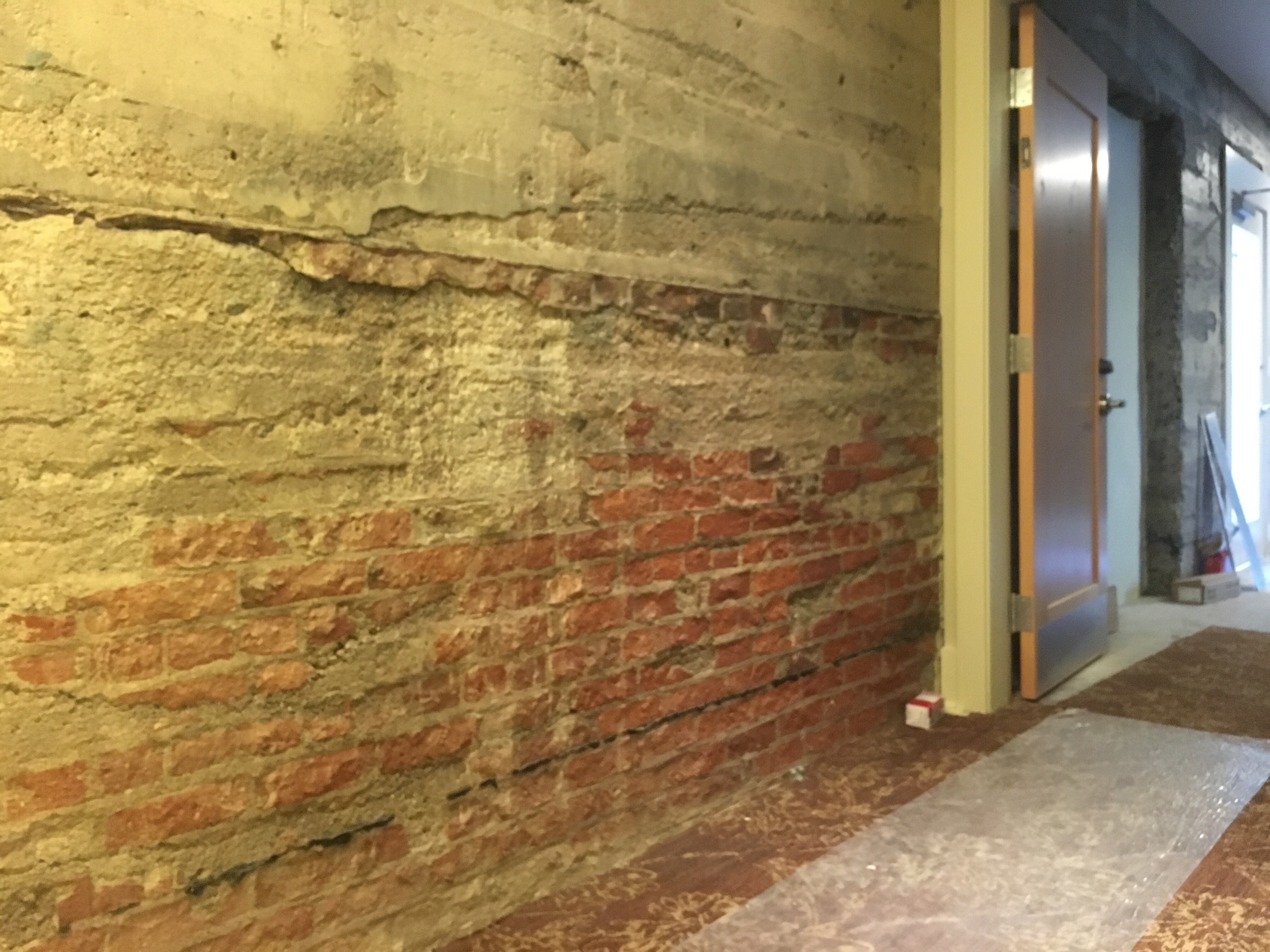Exposed historical brick wall from the old Lynden Department Store building, in the Inn at Lynden hall between guest rooms.