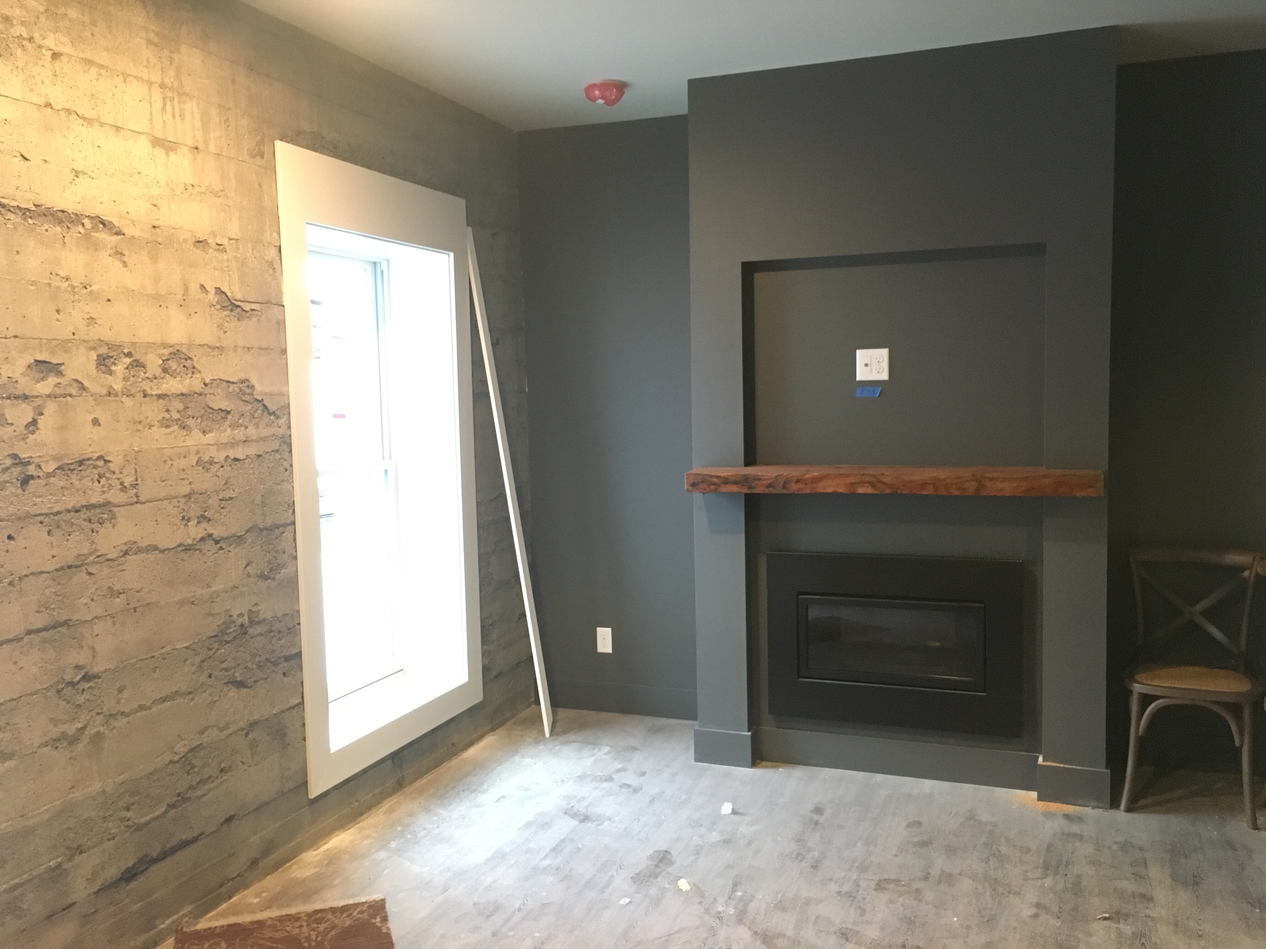 Construction phase of one of the Inn at Lynden rooms, including a fireplace and access to the open-air 'Skywell.'