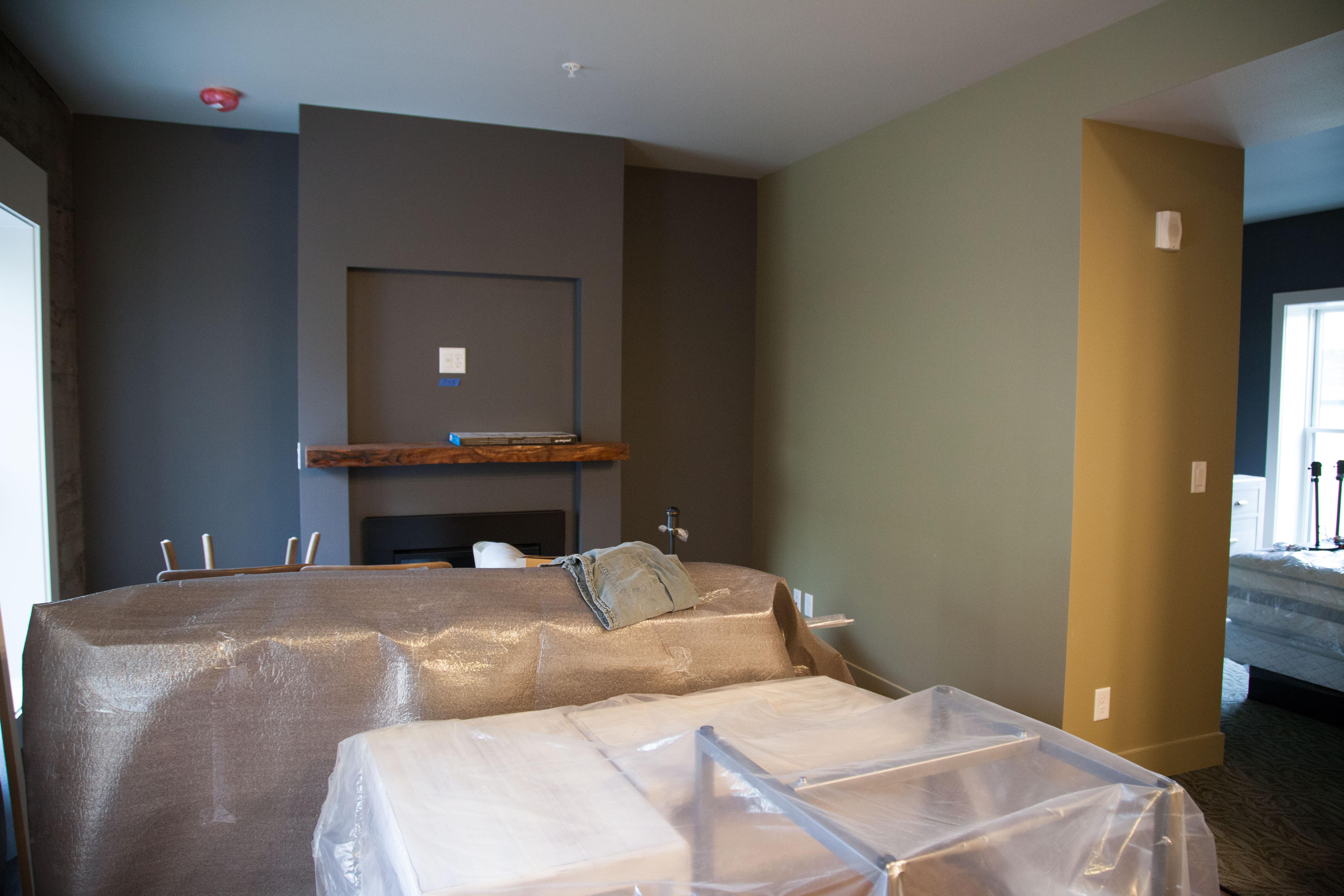 Extended stay Skywell room has its own fireplace, blocked by still-wrapped furnishings.