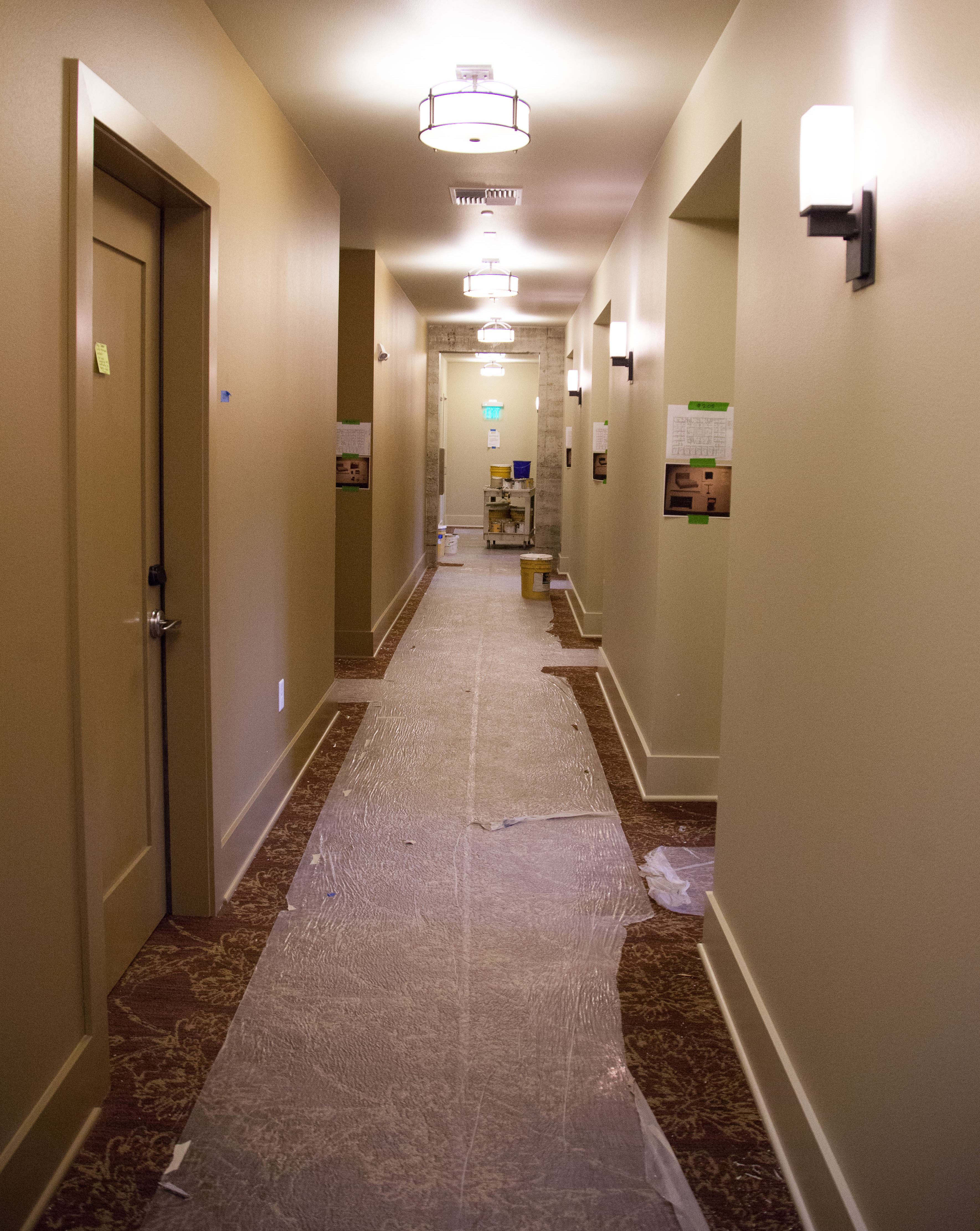 A hallway of rooms at the Inn at Lynden, with carpet protected during final construction.
